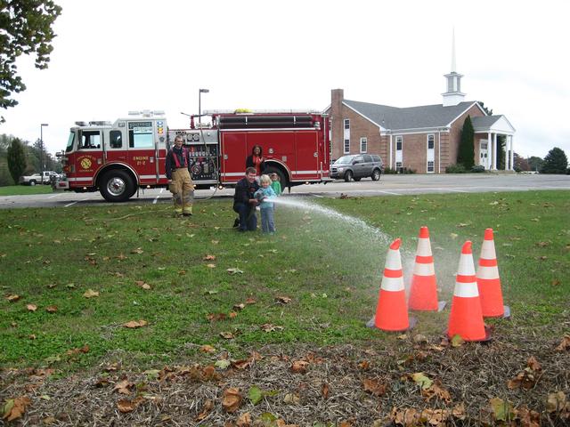 Hoseman Matt Groseclose showing kids how to operate the hose.